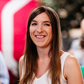 A photo of Sian smiling and looking just off camera. 