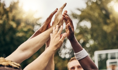 A group of people all high fiving together