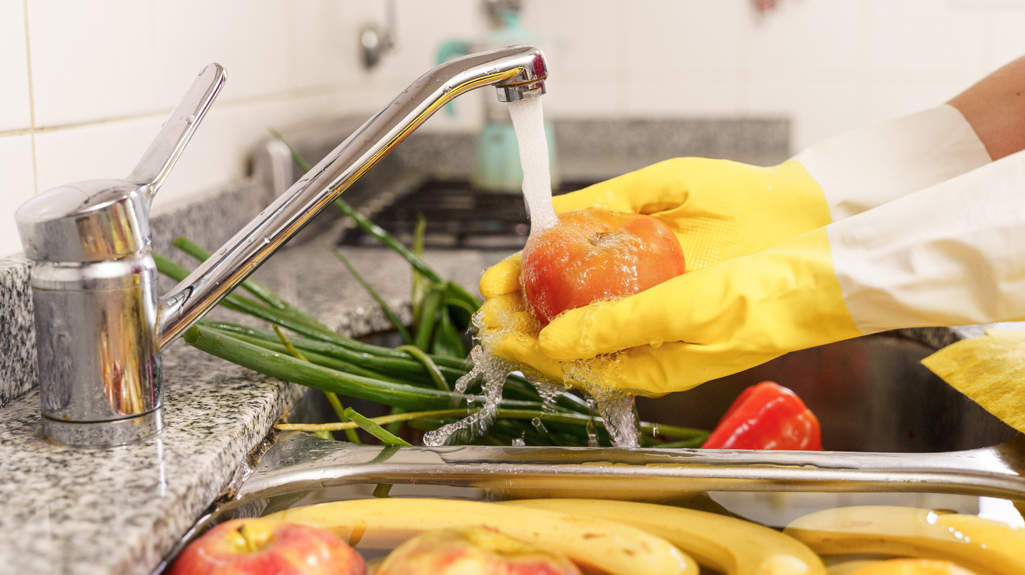 Photo of someone washing fruit and vegetables