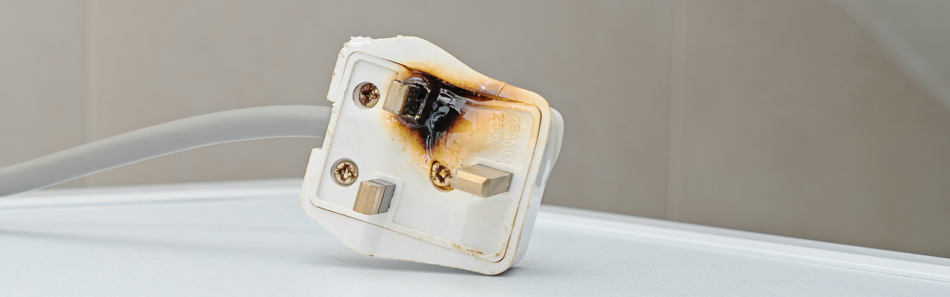 Plug that has been melted and burnt on one side
