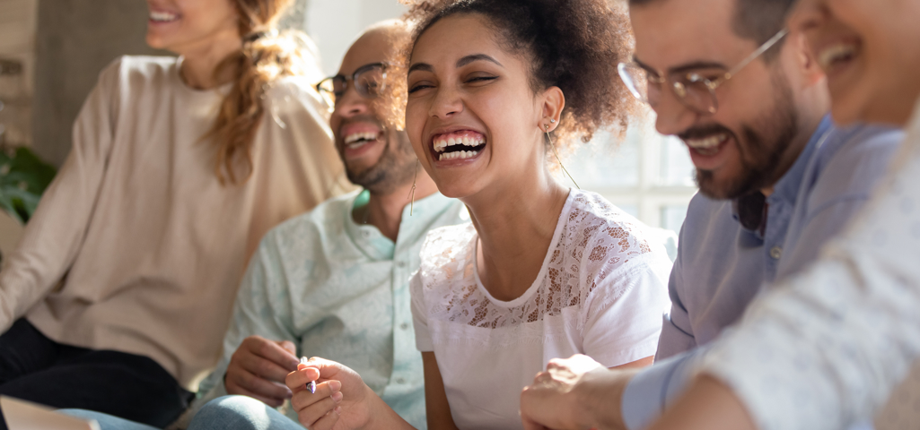 Group of five people laughing