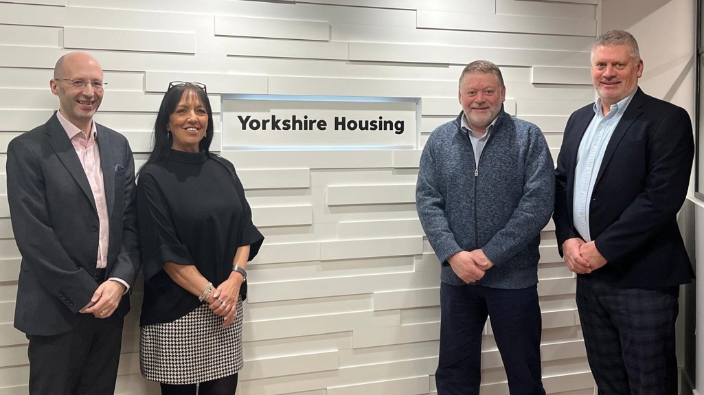 A group of people stood next to Yorkshire Housing sign