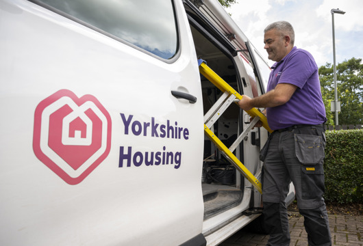 A Yorkshire Housing van with a colleague pulling a step ladder out  to do a repair