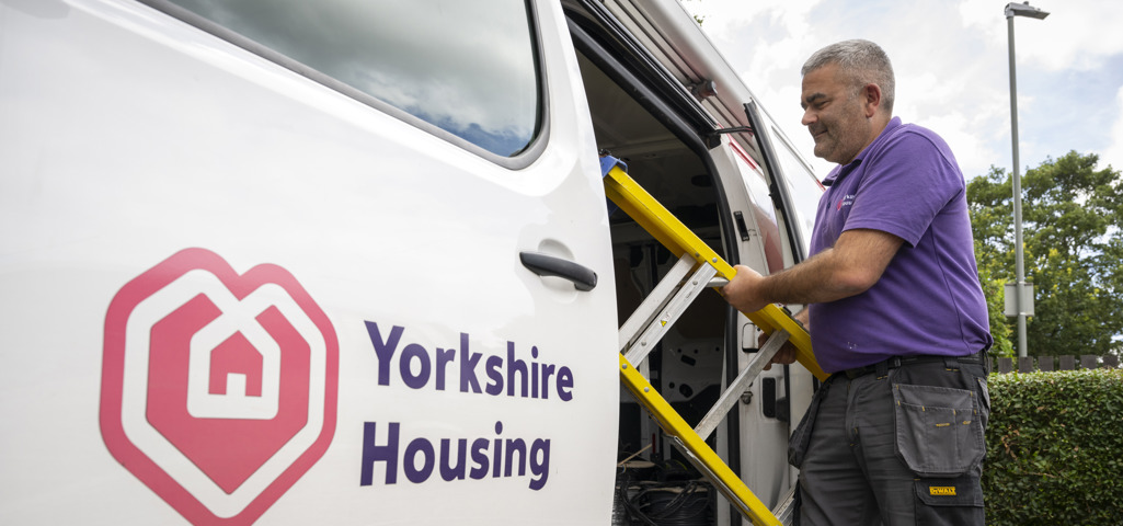 A Yorkshire Housing van with a colleague pulling a step ladder out  to do a repair