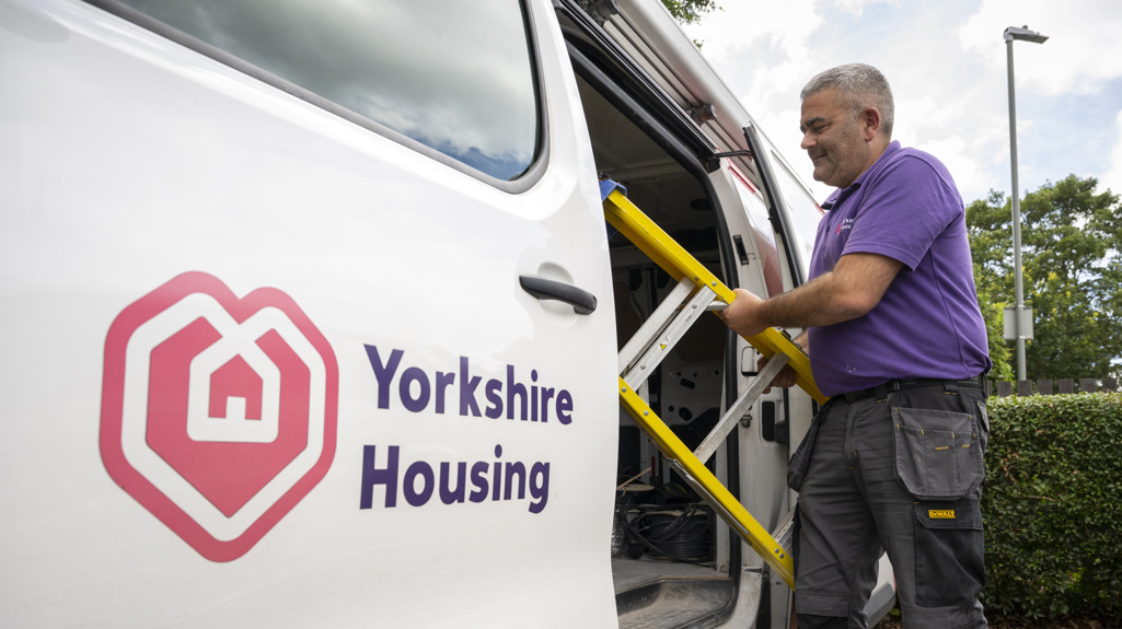 A Yorkshire Housing van with a colleague pulling a step ladder out  to do a repair