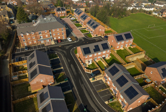 Aerial view of the St Andrews Grange development, showing new red‑brick houses with solar panels and surrounding streets.
