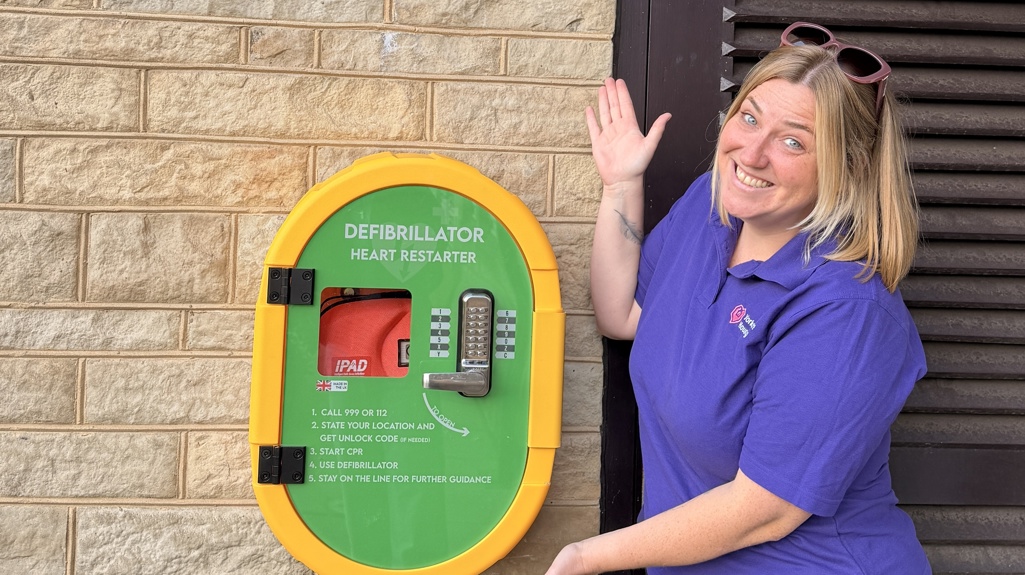 Fran standing next to one of the new defibrillators installed at a Yorkshire Housing scheme.
