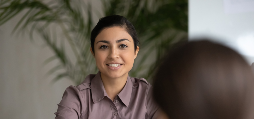 Woman sitting across desk from customer giving advice 
