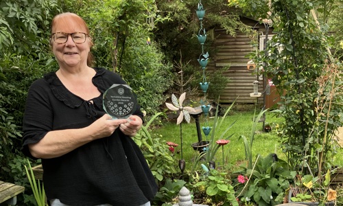 Our customer Mandy stood in her beautiful garden