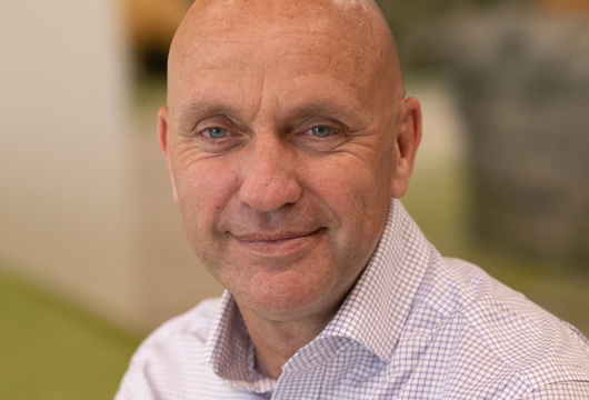 Man smiling at camera in office