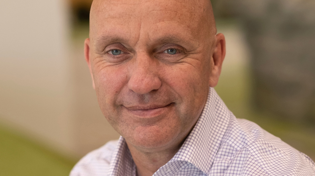 Man smiling at camera in office