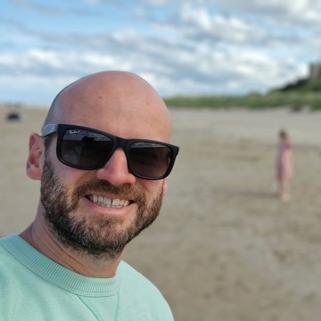 Rob at the beach with his sunglasses on 