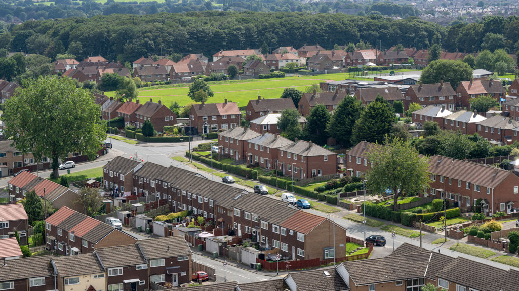 An aerial shot of Swarcliffe, showing terraced houses and green field space 