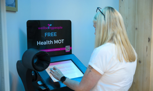 Colleague stood at a Health MOT stand