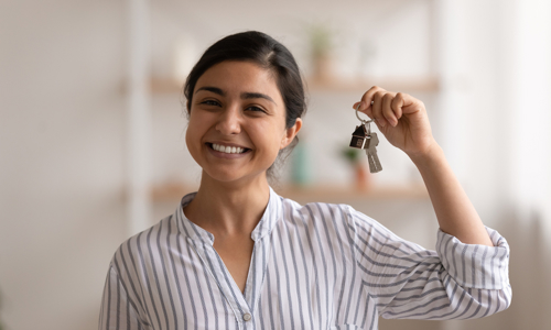 Woman smiling with bunch of house keys
