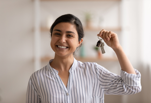 Woman smiling with bunch of house keys