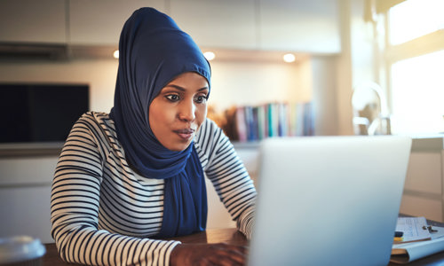 Women working at home and typing on a laptop