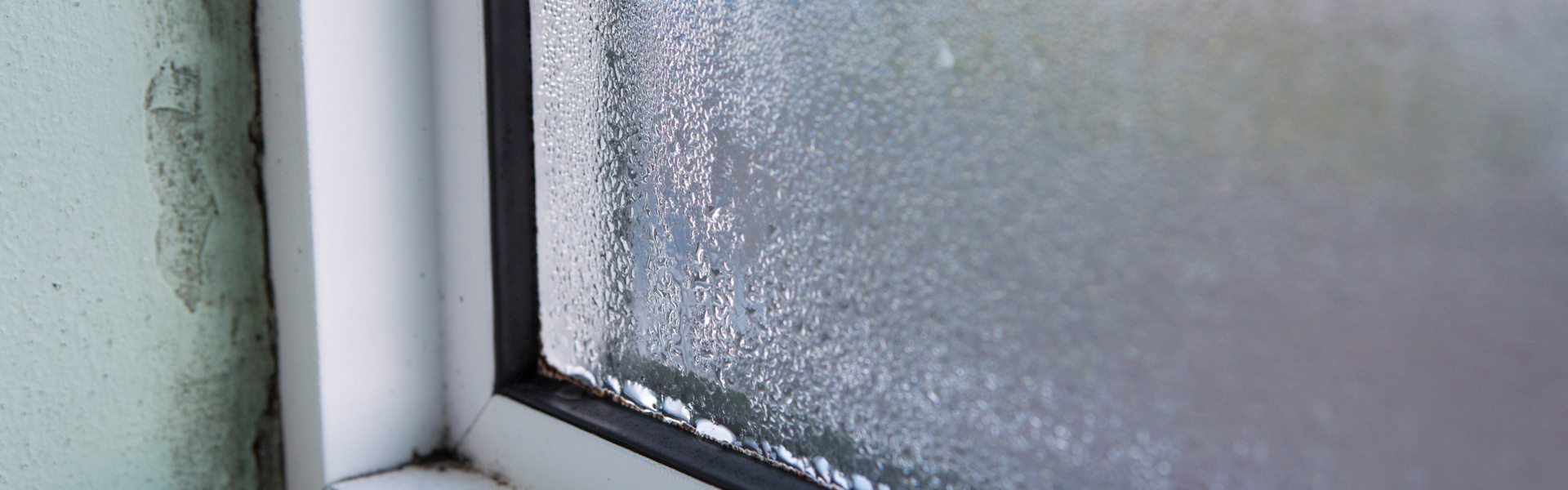 Condensation around a window with black mould around the seal