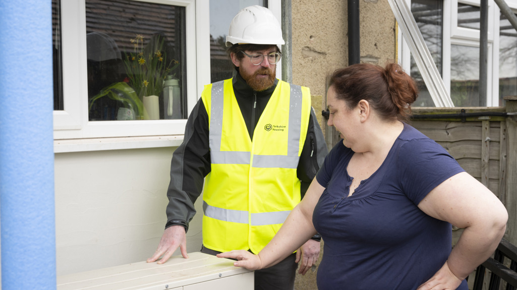 A customer with Yorkshire Housing staff outside a property