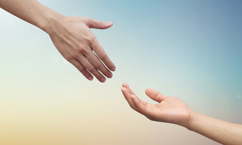Two hands reaching towards each other like they want to hold hands.