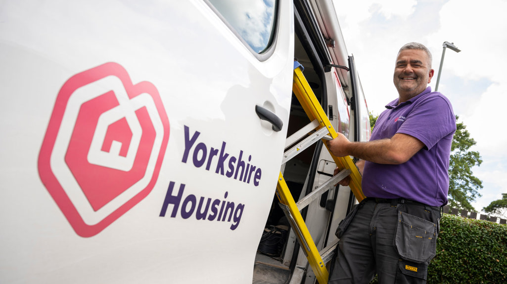 Colleague standing next to Yorkshire Housing van with a ladder