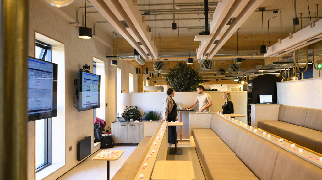 Presentation area with tiered seating and wall‑mounted screens.