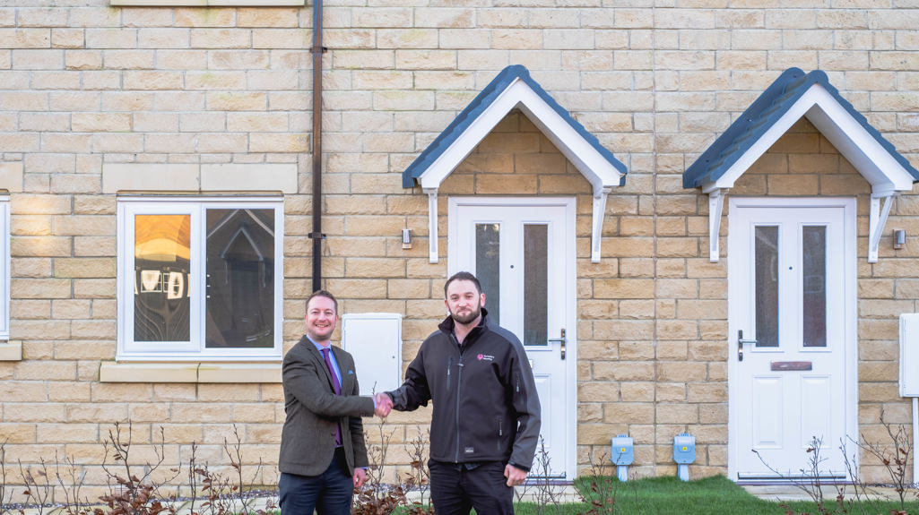 Joel Frank, Land Director at Charles Church Yorkshire shaking hands with Ed Blake, Land Buyer at Yorkshire Housing, at the Harrogate Harlow Hill development.