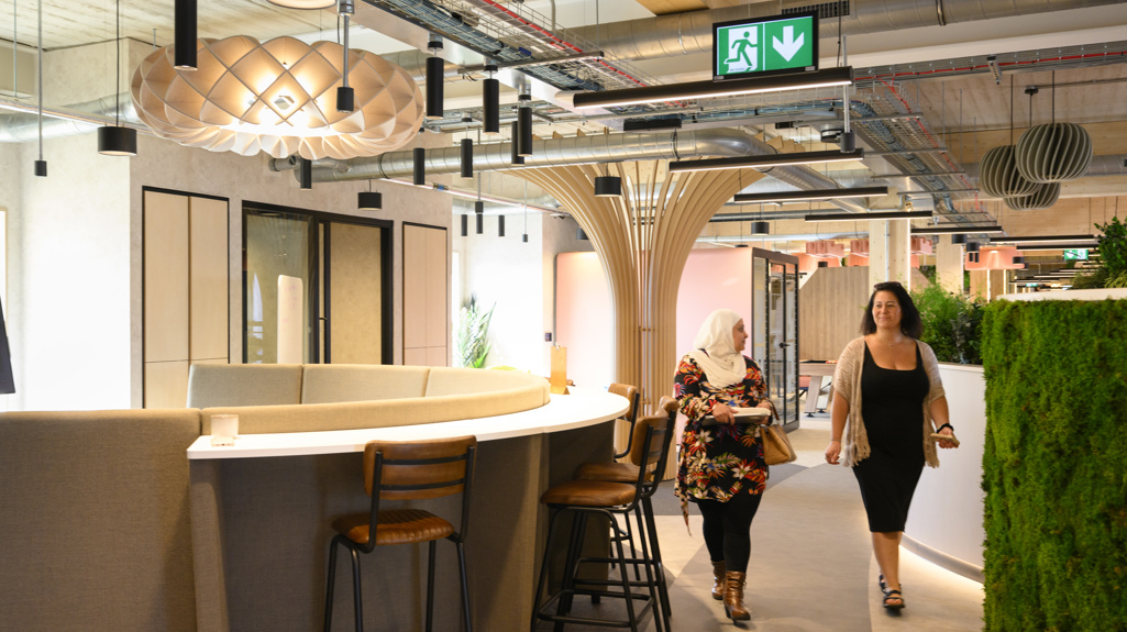 Office corridor with two woman walking through
