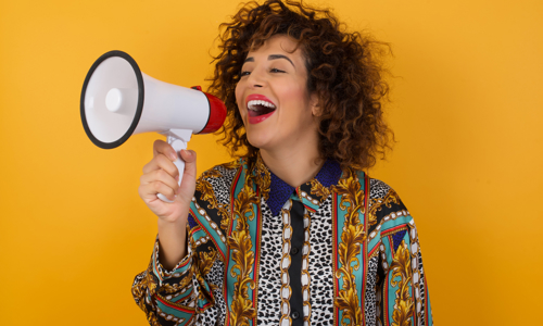 Young woman using megaphone