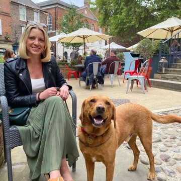 Picture of Nina Evison and her dog sat outside