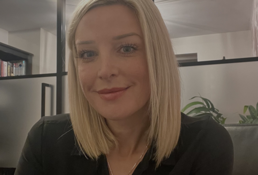 A headshot of Sarah